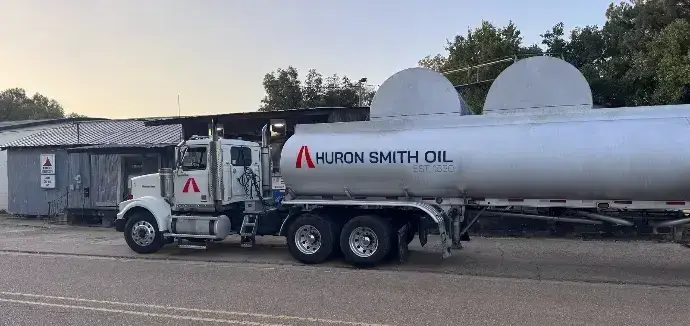 &#34;Modern Huron Smith Oil fuel truck parked beside a rustic service building at dusk in a framed oil painting-style artwork / HSO Technology